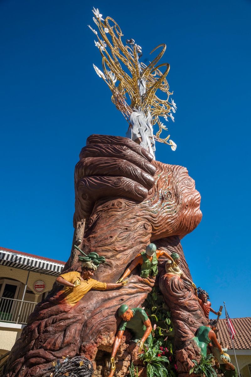 Side view looking up at the clasped hands and the gold and silver Tree of Life