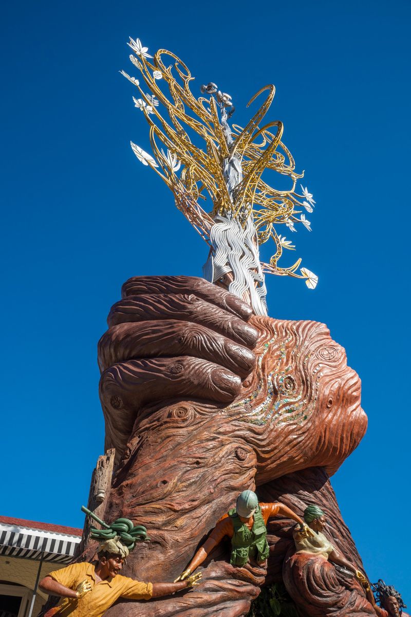 The clasped hands with a seam of glass mosaic, and the canopy above